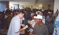 Crowd of villagers seek eye exams from visiting medical team